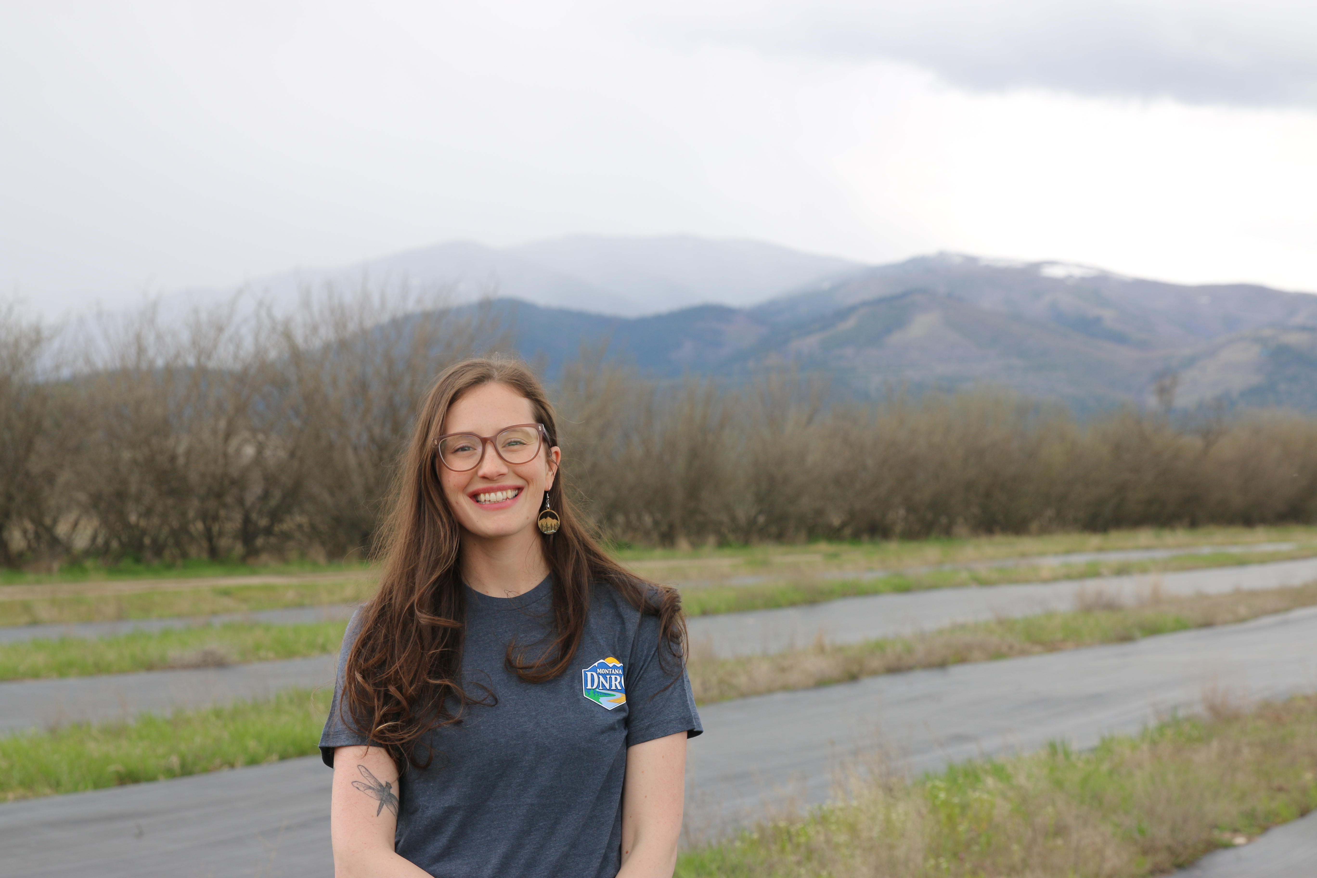 Woman smiling with DNRC shirt