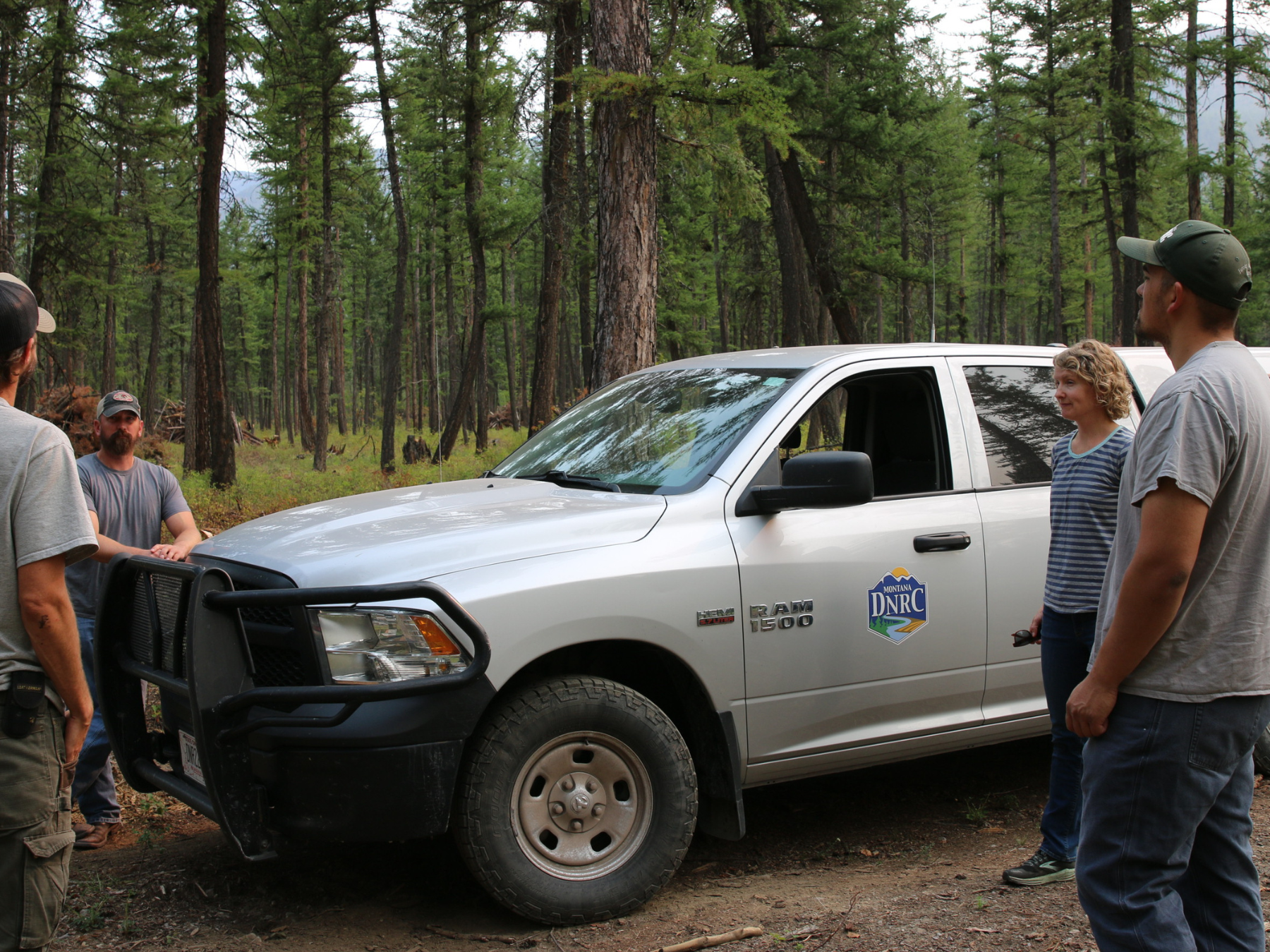 DNRC and partner forest managers discussing in forest