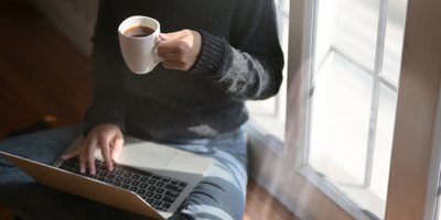 woman with laptop and cup of coffee