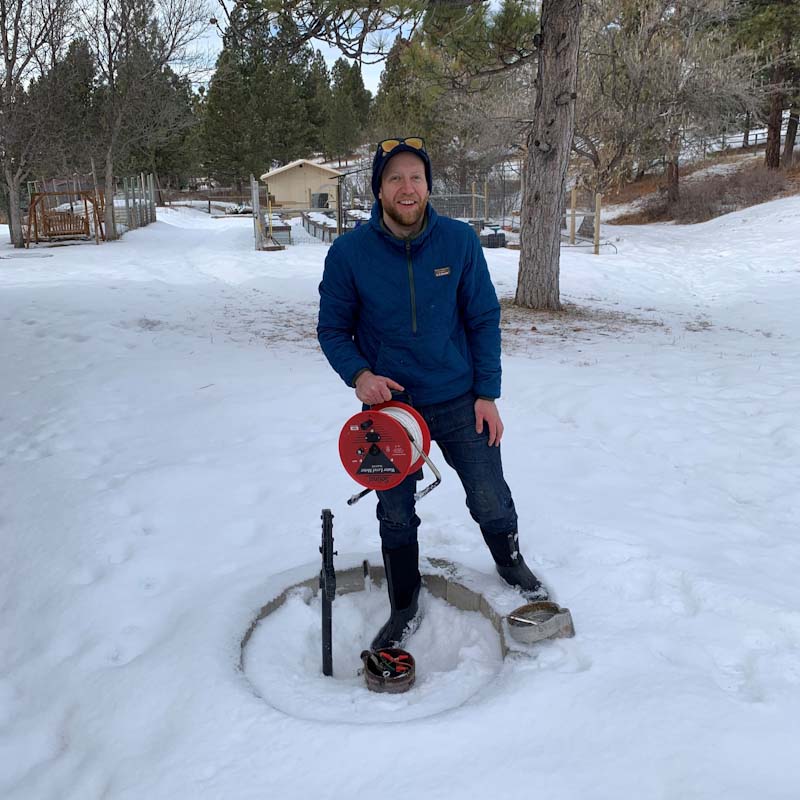 Person standing near groundwater well