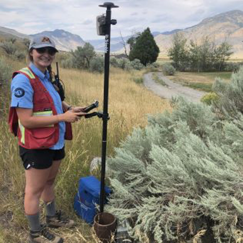 Woman standing by GPS