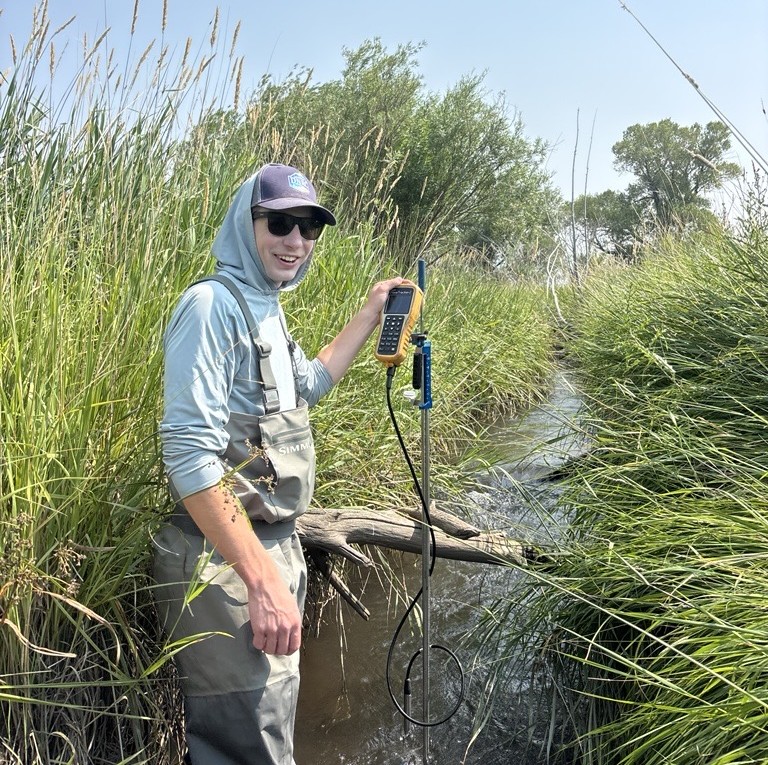 man standing in stream